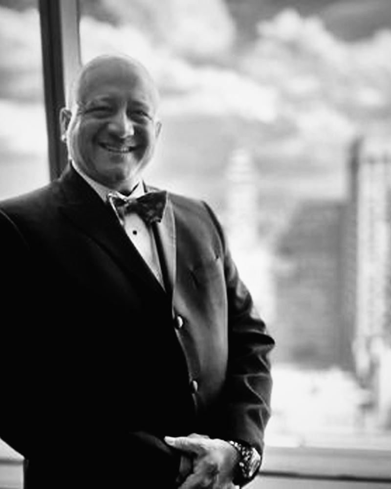 Black-and-white owner portrait for the shop craftsmanship section.